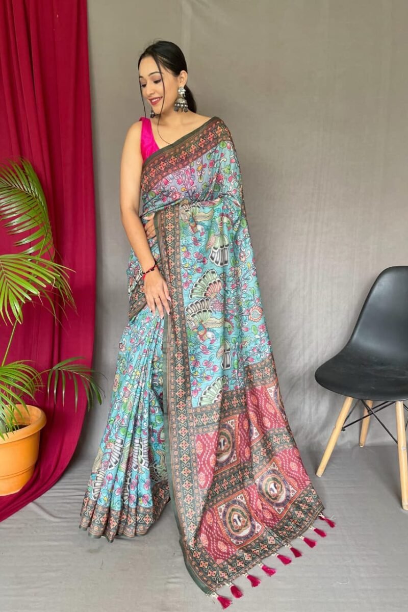 Sky blue malai cotton saree with Kalamkari inspired print, bold border and contrast tasselled pallu