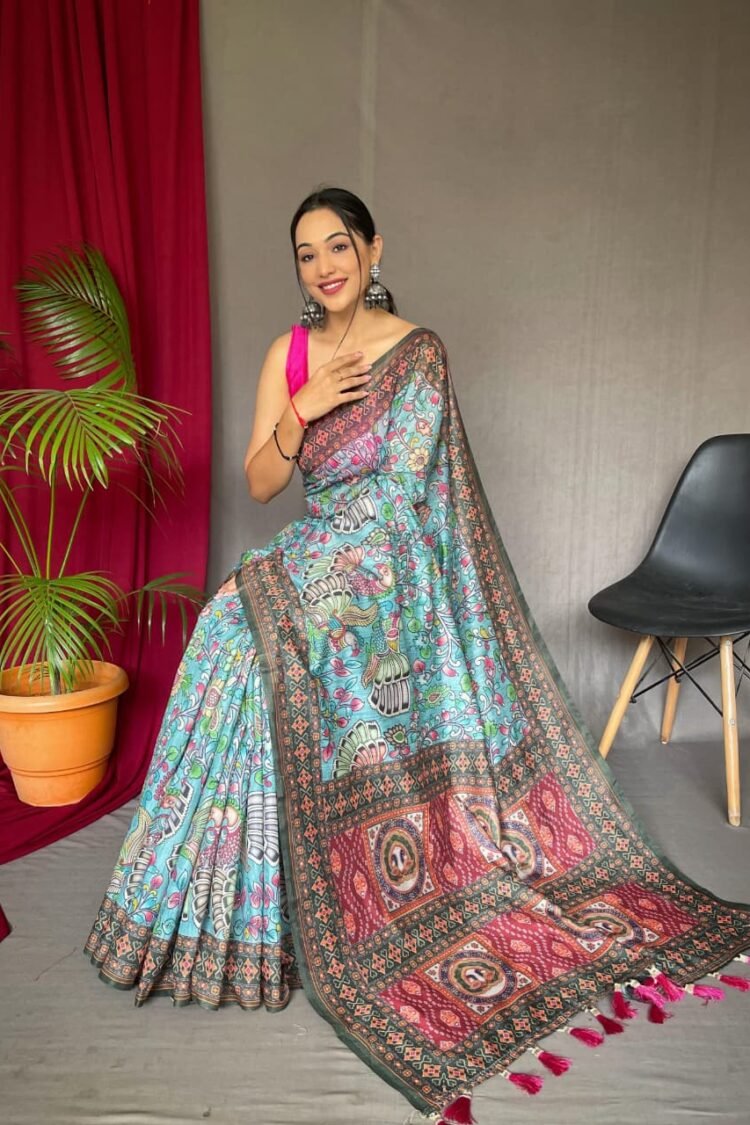 Sky blue malai cotton saree with Kalamkari inspired print, bold border and contrast tasselled pallu in front drape view
