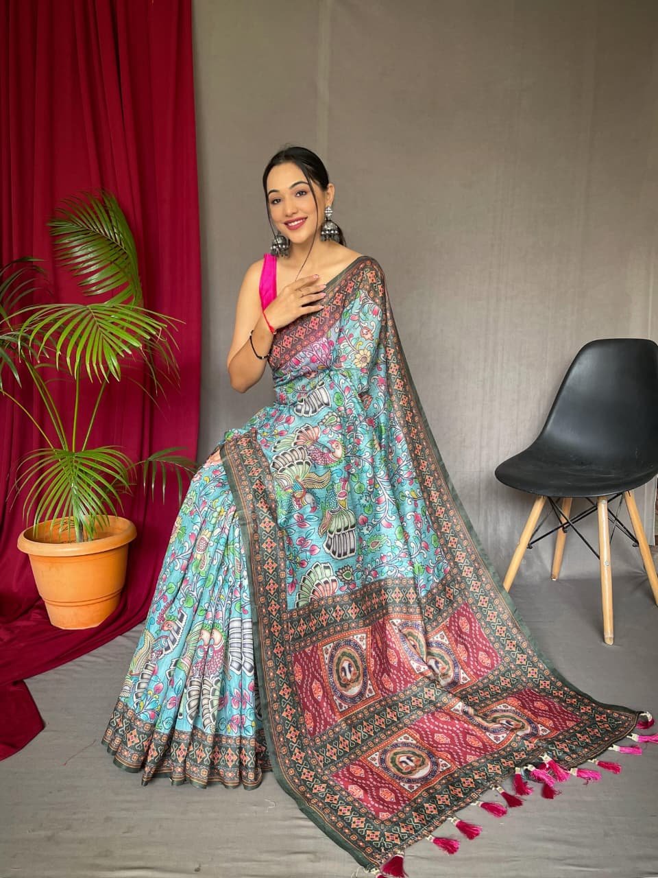 Sky blue malai cotton saree with Kalamkari inspired print, bold border and contrast tasselled pallu in front drape view
