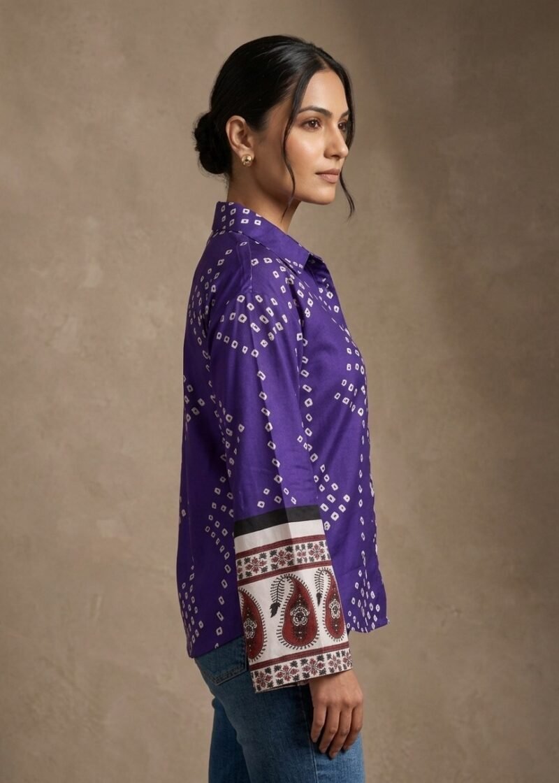 Side view of a woman wearing a purple printed shirt with full sleeves and ethnic border cuff detailing.