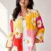 Woman wearing a yellow and pink floral linen blend shirt with white daisy print, button-down front, and relaxed fit sleeves.