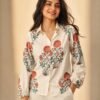 Women's off-white floral printed shirt featuring intricate red and sage green botanical motifs, collared neckline, full sleeves, and a relaxed fit.