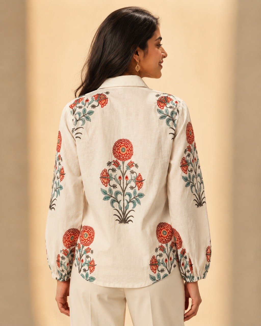 Back view of a women's off-white floral printed linen blend shirt featuring intricate red and sage green botanical motifs, full sleeves, and a relaxed silhouette.