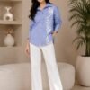 Full length view of women's blue striped floral print button-down shirt paired with white trousers DS024