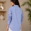 Back view of women's blue striped long sleeve button-down shirt with collared neckline and relaxed fit DS024