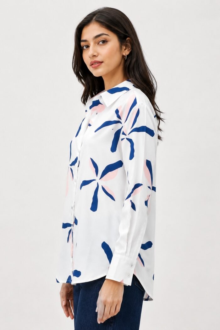 Side view of a women's white printed shirt with abstract navy blue and blush pink floral motifs, featuring a collared neckline, full sleeves, and a relaxed fit silhouette.