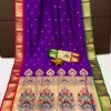 A purple Kanchipuram Paithani silk saree with a peacock design.