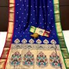 A navy blue Kanchipuram Paithani silk saree with a peacock design.