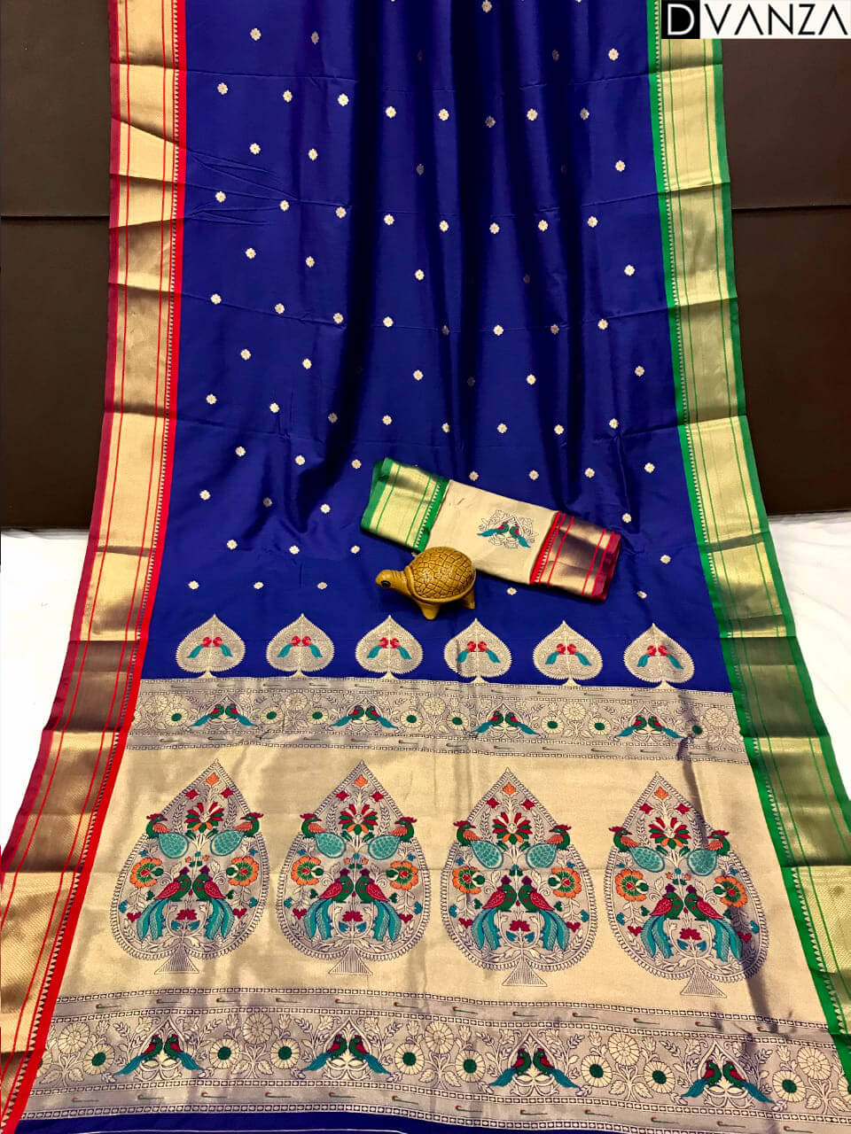 A navy blue Kanchipuram Paithani silk saree with a peacock design.