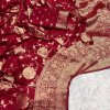 Close-up of the ornate woven border on a maroon pure georgette silk saree.