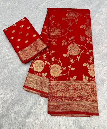 Close-up of the heavy zari woven border on a red pure georgette silk saree.